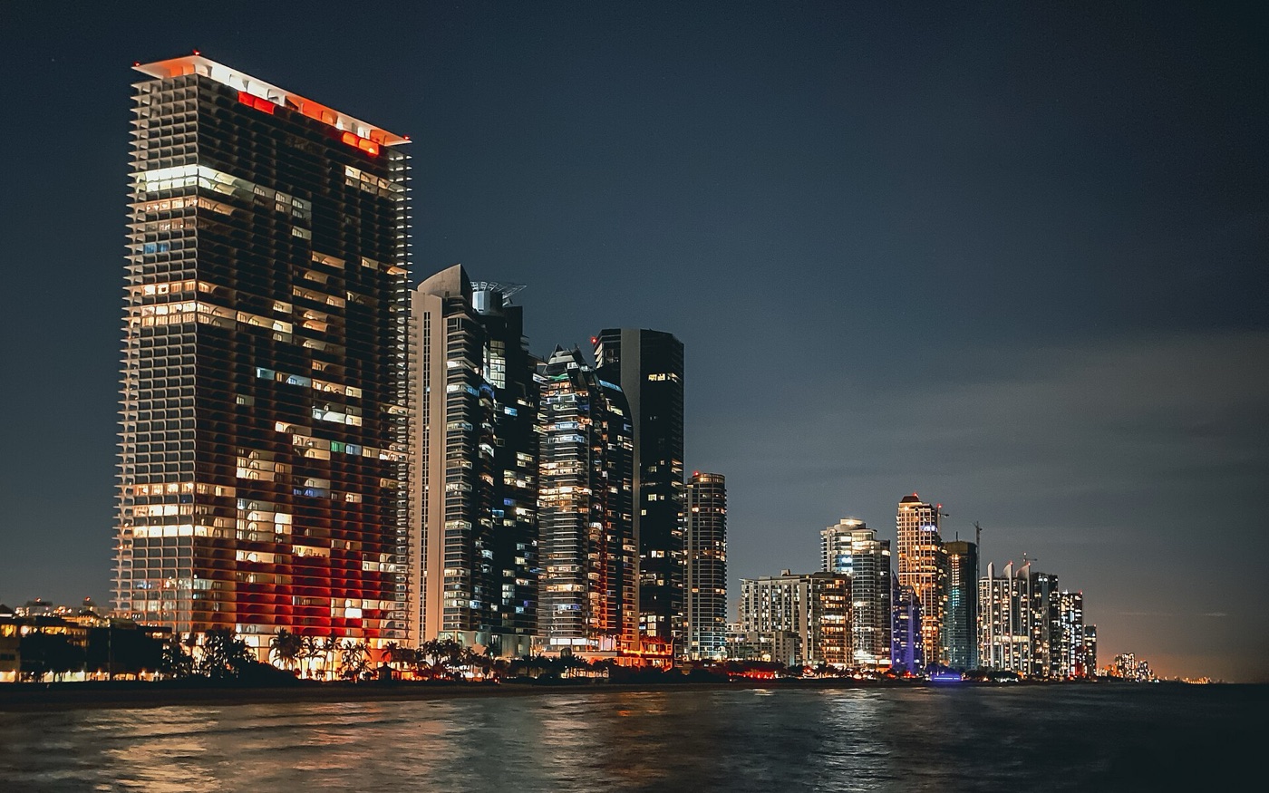 Miami skyline at night from the ocean — the festival's home city
